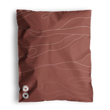 A brown pillowcase with wavy white lines and two small round patches at the bottom, reminiscent of the design on Tidal Terracotta Mailers 10" x 13" by impack.co.