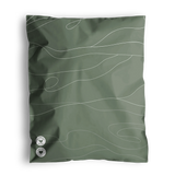 A green pillowcase with white wavy lines design. Two small round buttons with symbols are located at the bottom left corner, reminiscent of the careful detailing found in impack.co's Tidal Moss Mailers 10" x 13" used for medium-sized shipments.