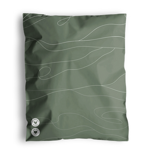 A green pillowcase with white wavy lines design. Two small round buttons with symbols are located at the bottom left corner, reminiscent of the careful detailing found in impack.co's Tidal Moss Mailers 10" x 13" used for medium-sized shipments.