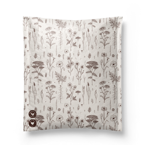 The Wildflower Biodegradable Bubble Mailers by impack.co measure 10" x 13" and feature a square fabric design with a beige background and repeating wildflower pattern. They offer eco-friendly protection with three certification logos in the bottom left corner, highlighting their sustainability commitment.