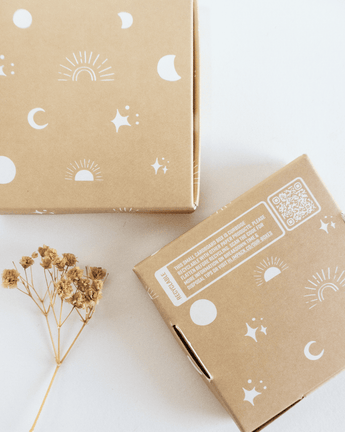 An ABC Box Celestial 4" x 4" - Small from impack.co, with a flower and a sun on it, featuring celestial print.