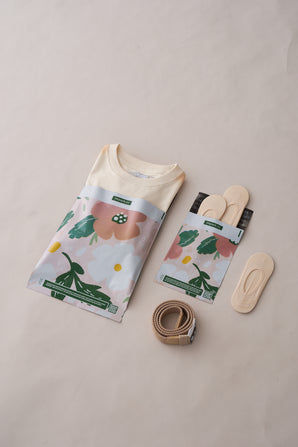 The impack.co Pastel Petals Mailers 6" x 9" are displayed on a light background, accompanied by two pairs of beige insoles (one in eco-friendly packaging, one loose) and a rolled beige belt.