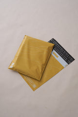 The Tidal Amber Mailers 10" x 13" by impack.co, featuring yellow padding and black adhesive strips, are showcased with one partially covering the other. These biodegradable envelopes offer a practical, eco-friendly solution for medium-sized shipments on a neutral backdrop.