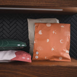 A set of Celestial Tan Mailers 10" x 13" on a wooden shelf made by impack.co.