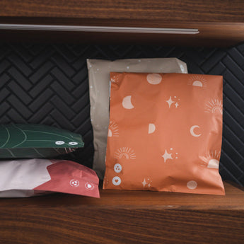 A set of Celestial Tan Mailers 10" x 13" on a wooden shelf made by impack.co.