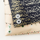Two impack.co gift bags featuring "Eco Conscious Material" and "Made With Love" labels sit stacked, highlighting festive packaging. Perfect for gifting and a great match for SALE - Christmas Light Strings Biodegradable Mailers 10" x 13" US.