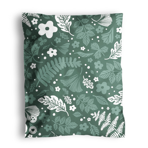 Decorative floral pattern on a fabric with a folded corner, wrapped in impack.co's Emerald Evergreen Biodegradable Mailers 10" x 13".