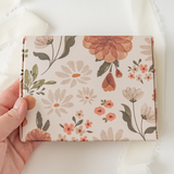 A hand holding an impack.co Gardenlumina print-patterned ABC Box 4.8" x 6" - Medium book or journal.