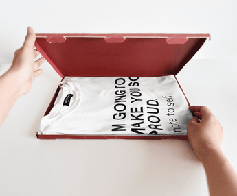 A person holding a ABC Box Cedar Leaf 9.8" x 13.3" - Extra Large by impack.co with a t-shirt inside for shipping.