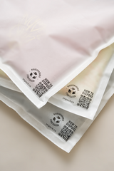 Three impack.co Glassine Bags 9.6" x 12.6" with QR codes and disposal instructions printed at the bottom corners. The text includes "HOW TO DISPOSE" and the website "impack.co.