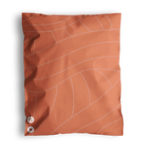 The SALE - Natural Cedar Leaf Biodegradable Mailers by impack.co showcases a delicate Cedar Leaf design on its orange pouch. It is accented with two round symbols at the bottom left corner. These mailers offer robust protection for their contents and emphasize an eco-friendly approach.