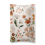 A Gardenlumina Padded Paper Mailers 6" x 9" with curled pages, featuring a design of various flowers and leaves in soft colors on FSC-Certified Paper.