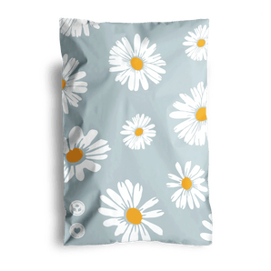 A light blue pillowcase featuring white daisies with orange centers is thoughtfully shipped using impack.co's sustainable 6" x 9" Daisy White Biodegradable Mailers.