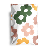 A pillowcase showcasing a Cosmos print with bold flowers in green, yellow, and pink set against a white backdrop.