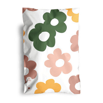 A pillowcase showcasing a Cosmos print with bold flowers in green, yellow, and pink set against a white backdrop.