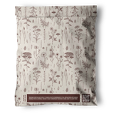 A beige, resealable impack.co Wildflower Biodegradable Mailer (19" x 24") features brown botanical illustrations and a QR code at the bottom right. Text below highlights its eco-conscious, recyclable, and compostable packaging.