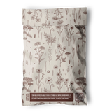 The Wildflower Biodegradable Mailers 6" x 9" by impack.co feature cream-colored bags with brown floral designs, eco-friendly labels, a QR code for info, and are ideal for sustainable shipping.