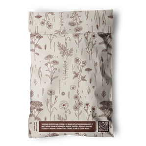 The Wildflower Biodegradable Mailers 6" x 9" by impack.co feature cream-colored bags with brown floral designs, eco-friendly labels, a QR code for info, and are ideal for sustainable shipping.