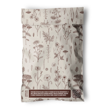 The Wildflower Biodegradable Mailers 6" x 9" by impack.co feature cream-colored bags with brown floral designs, eco-friendly labels, a QR code for info, and are ideal for sustainable shipping.