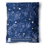 The Midnight Indigo Mailers 10" x 13" by impack.co come in a resealable blue bag with floral and star designs; the bottom label highlights eco-friendly, recyclable packaging and features a QR code.