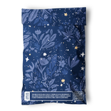 The impack.co Midnight Indigo Mailers 6" x 9" are blue, recyclable bags with floral and star patterns, perfect for shipping small accessories or jewelry. A sustainability message and QR code are printed near the bottom.