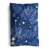 The decoratively adorned "SALE - Midnight Indigo Mailers 6\" x 9\"" by impack.co features sustainable dark blue fabric with leaf, star, and flower motifs in lighter hues. Two circular labels at the bottom left enhance its charm.