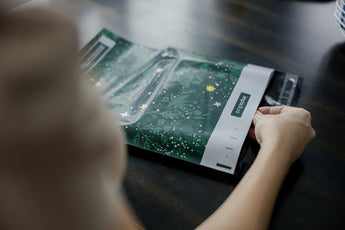 A woman holding a Midnight Lush Mailers 14.5" x 19" from impack.co.