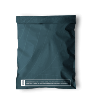 Back view of a Space Blue Leaf Biodegradable Mailers 14.5" x 19" with a white label on it from impack.co.