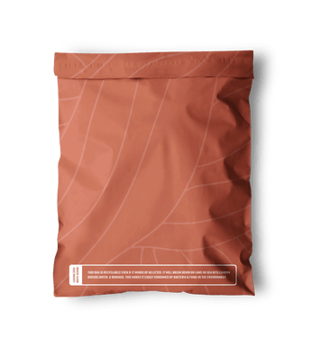 The SALE - Natural Cedar Leaf Biodegradable Mailers from impack.co, featuring a brown background with a cedar leaf design and white text highlighting its environmental benefits, boast a durable and eco-friendly construction. They measure 14.5" x 19".